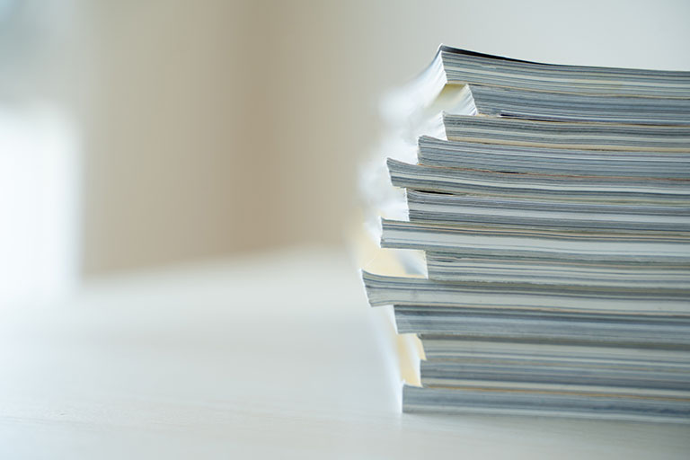 Several medical journals stacked on a table