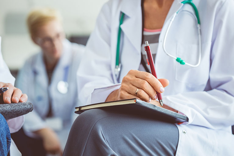 Interventional cadiologist taking notes
