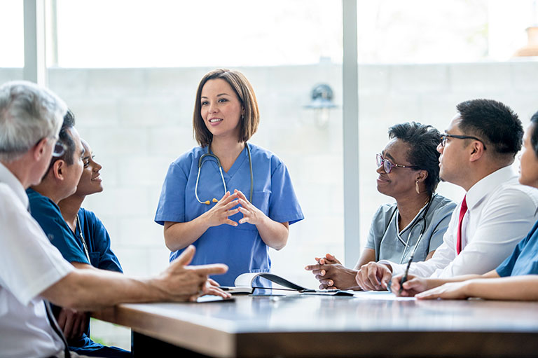 Female-doctor-presenting-at-a-meeting