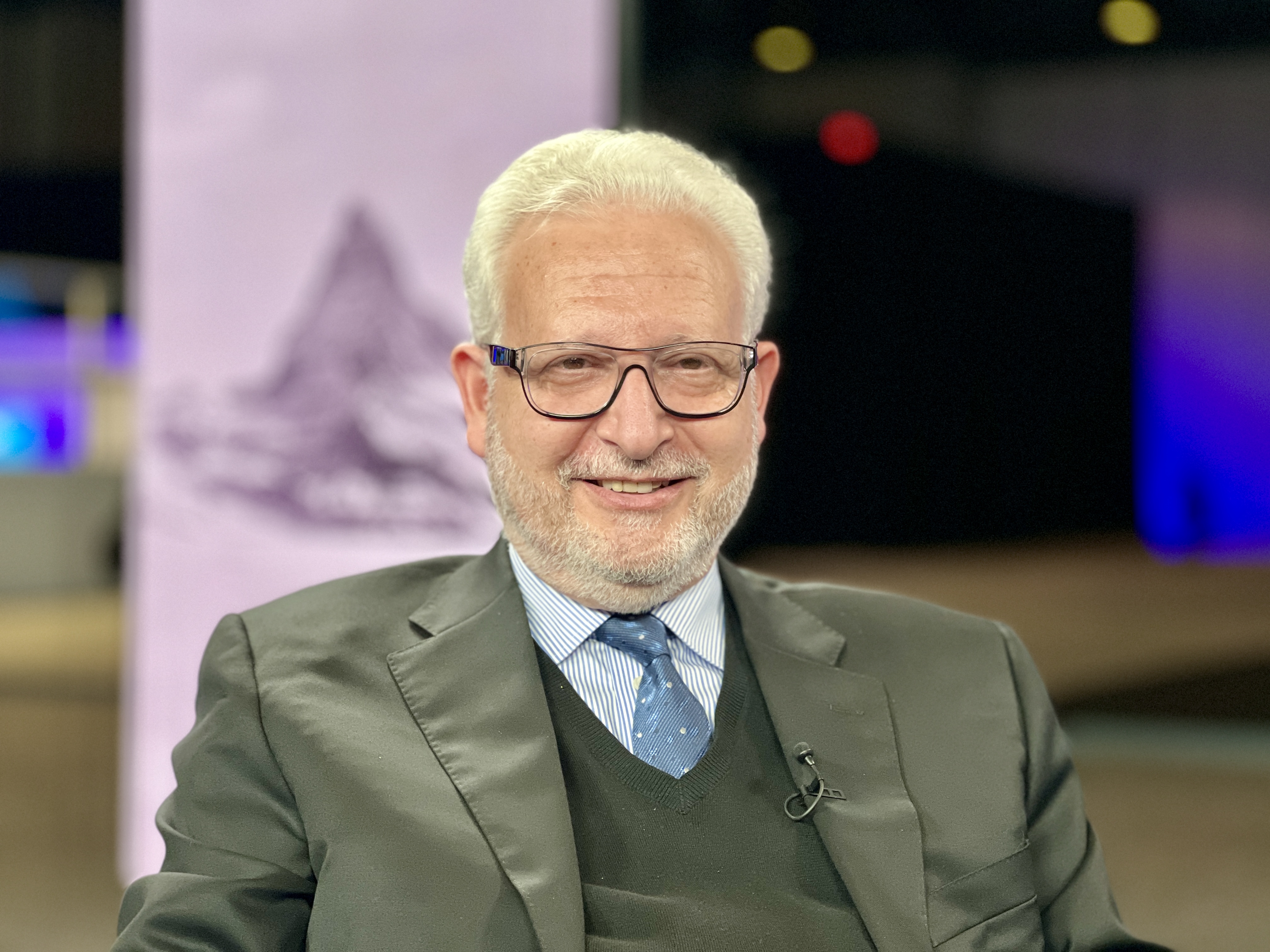 Male doctor researching on laptop