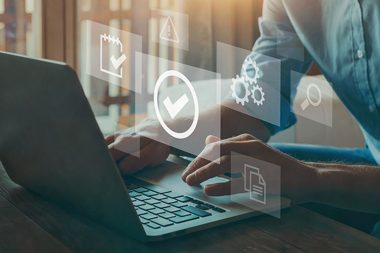 Male doctor researching on laptop